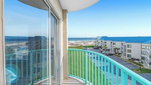 A balcony with a view of a beach and a parking lot. - Gulf Shores Plantation-Palms 6512 (Gulf Shores)