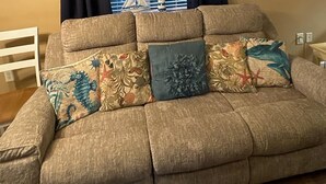 A sectional sofa with multiple cushions in a living room. - Beautiful 12th Floor Oceanfront Get Away in North Myrtle Beach (North Myrtle Beach)