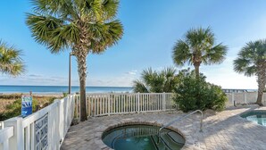 A pool area with a view of the beach, a white fence, and palm trees. - Beautiful 12th Floor Oceanfront Get Away in North Myrtle Beach (North Myrtle Beach)