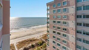 A high-rise building with multiple windows overlooking a beach. - Beautiful 12th Floor Oceanfront Get Away in North Myrtle Beach (North Myrtle Beach)