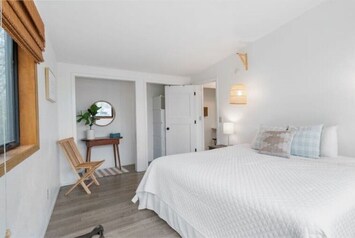 Upstairs king bedroom with make up stand and mirror to get ready.