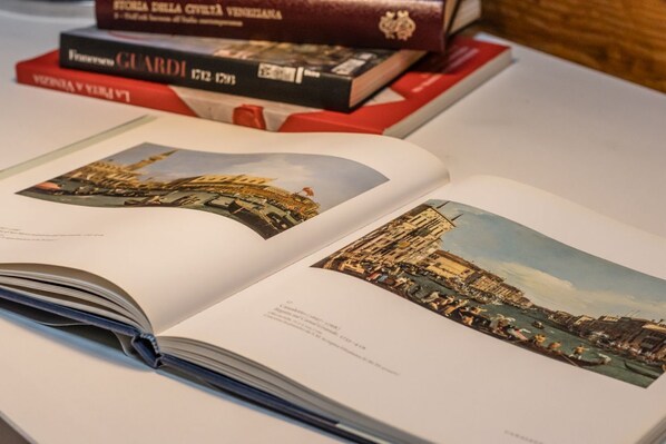 An open book with pages displaying images of a historical building and a cityscape.