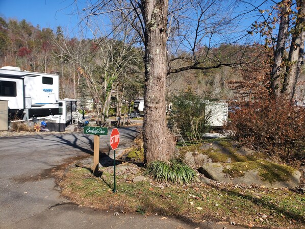 A campground with RVs, a stop sign, and a sign for Creasey Drive.