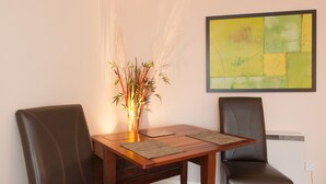 A dining area with two chairs, a table, and a decorative plant. - A modern 2-bedroom apartment in a quiet neighbourhood . Sleeps 4 (Edinburgh)