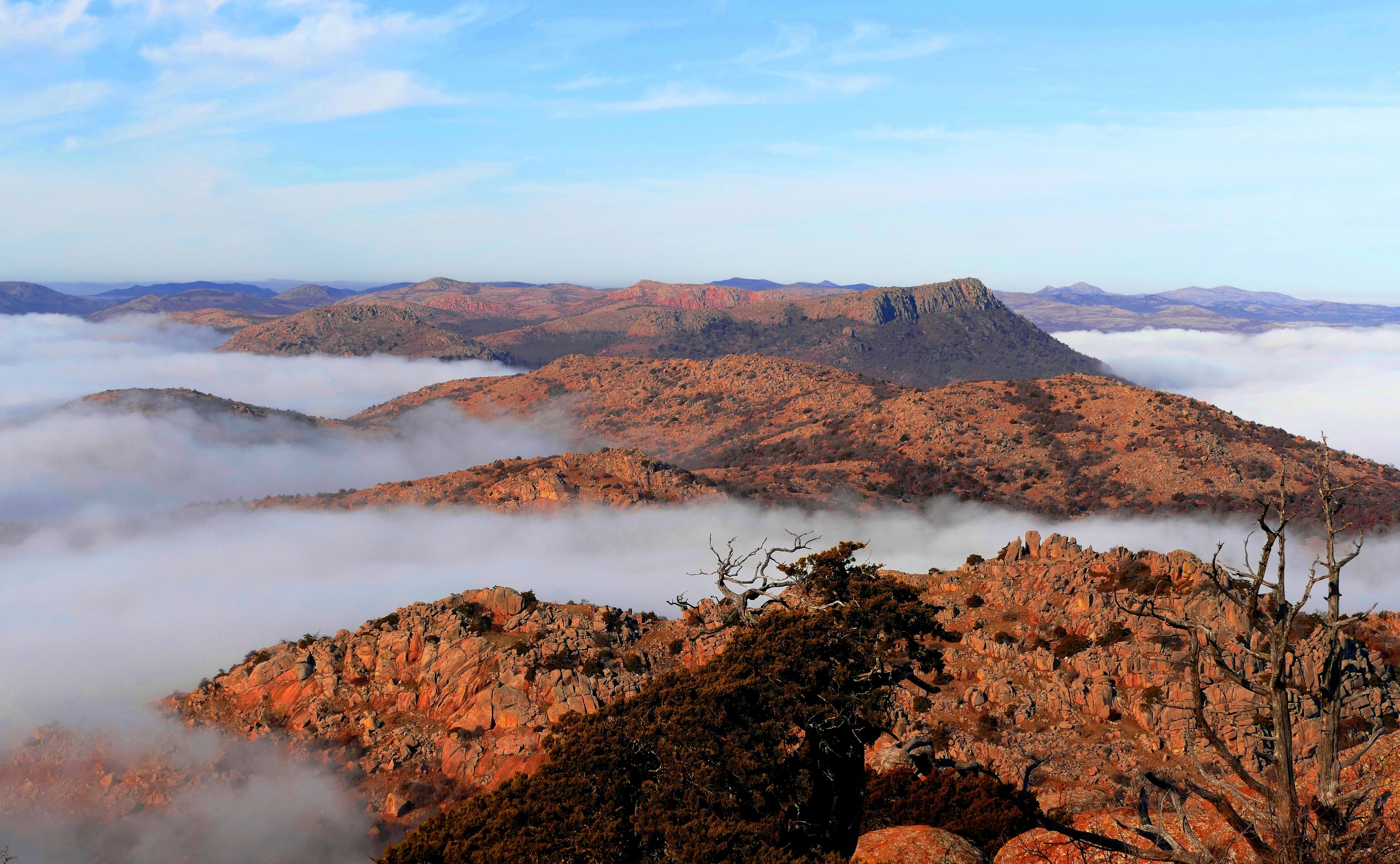 A rugged mountain landscape with rocky terrain and sparse vegetation.