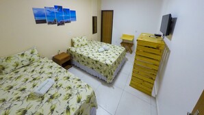 A hotel room with two beds, a TV, a wooden dresser, and a small table. - Pousada Barra Grande (Maragogi)