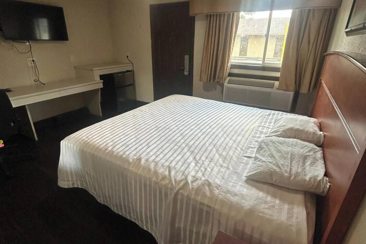 Room (1 King Bed & 1 Queen Bed) | 1 bedroom, desk, iron/ironing board, free WiFi