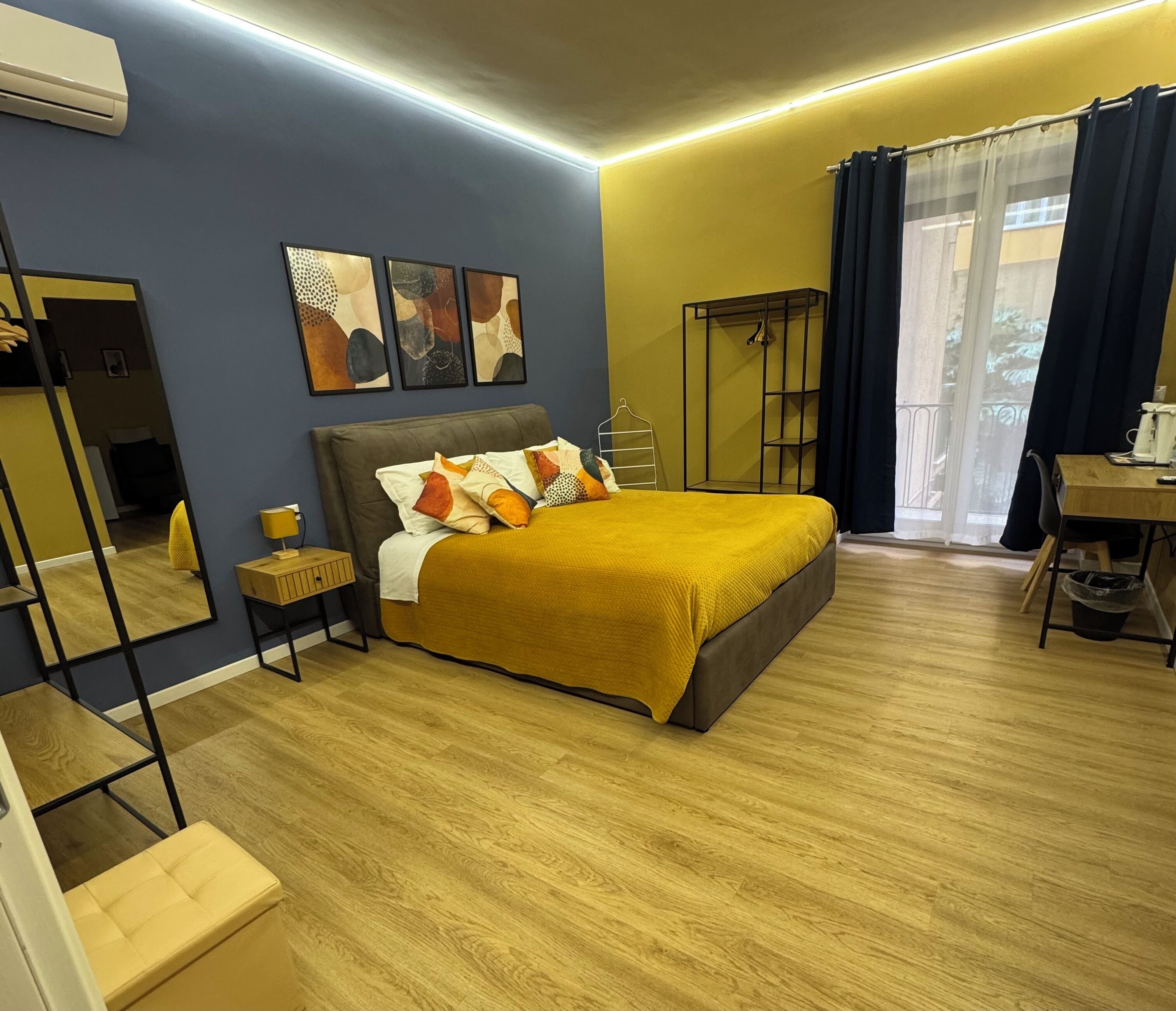 A bedroom with a bed, bedside table, and a wardrobe.
