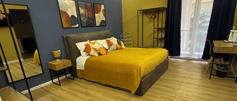 A bedroom with a bed, bedside table, and a wardrobe.