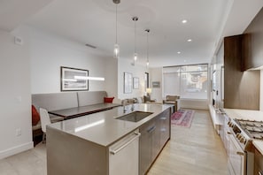 A modern kitchen with a central island, stainless steel appliances, and pendant lighting. - LIFT 114 | Ski-In/Out Next to Sunrise Lift | Village View | Kitchen | Hot Tub | Pool (Park City)