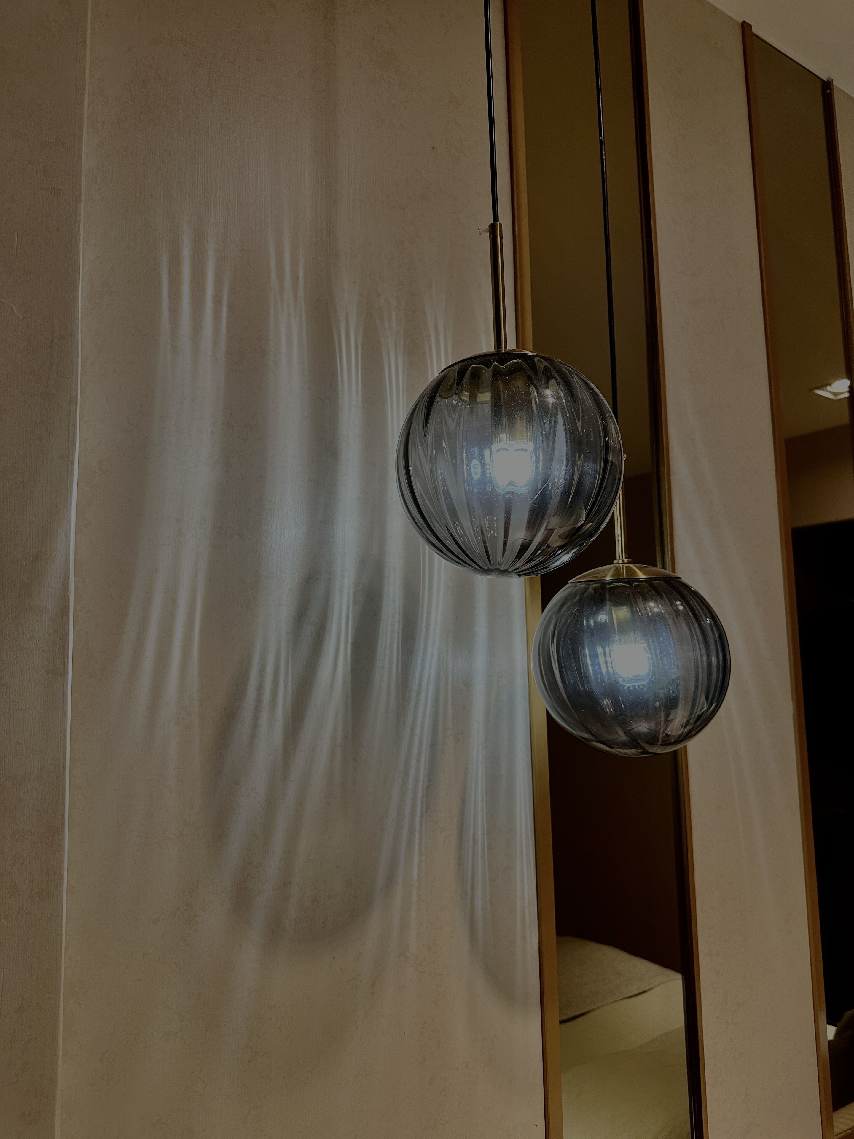 A modern interior with two spherical pendant lights hanging from the ceiling.