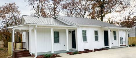 A single-story house with a front porch, a covered entryway, and a small front yard.