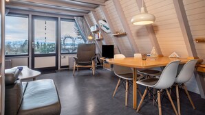 Et moderne interiør med spisebord, stole, sofa og fjernsyn.