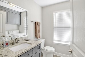 A bathroom with a sink, mirror, and toilet. - Atlas Townhome #B~Milton,Pensacola,Navarre~Close (Milton)