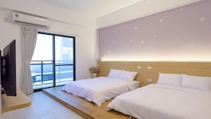 A hotel room with two beds, a TV, a large window with curtains, and a wall with star decorations. - Sunny Day Homestay (Magong)