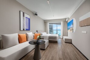 Enjoy a peaceful retreat with a large window offering a view of the outdoors, a flat-screen TV, and a cozy seating area.