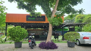 Un restaurante llamado "Barata Cafe & Resto" con terraza y plantas en macetas.