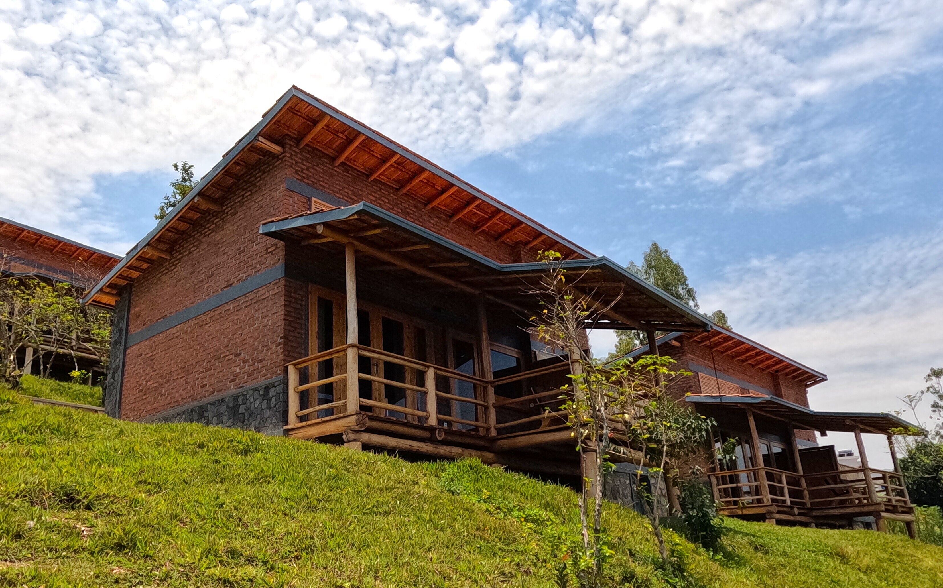 A rustic lodge with a wooden balcony and stone foundation.