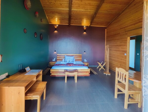 A wooden-paneled room with a bed, wooden desk, and chair. - Umutuzo Lodge Kivu Lake (Boneza)