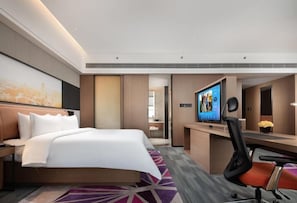 Relax in a spacious room with a large bed, city views, and a flat-screen TV.