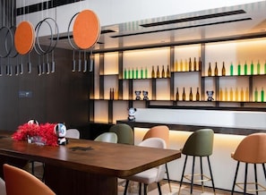 Enjoy dining and meeting in this stylish space with a long table and comfortable seating.