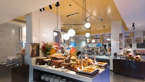 A buffet area with various food items and a decorative centerpiece.