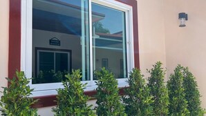 A building with a large window and a sign above it. - PICHAPON  RESORT (Pak Chong)