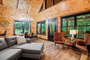 Relax in this inviting space with a large sectional sofa, armchairs, and a dining area.