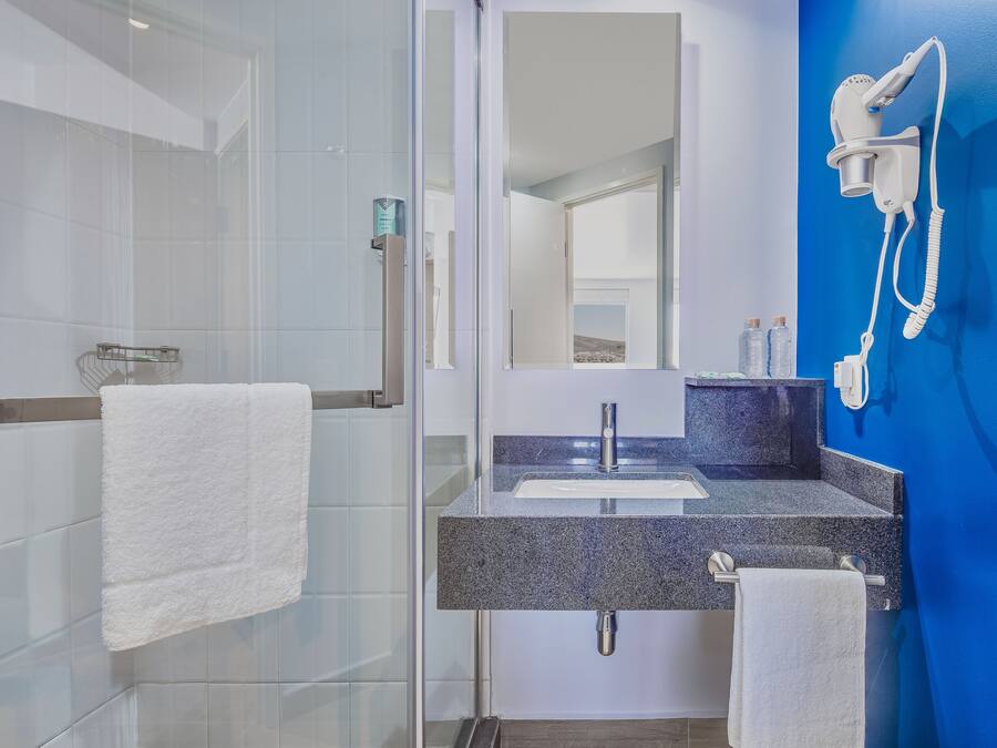 Shower, rainfall showerhead, hair dryer, towels