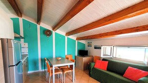 A compact living space with a kitchen, dining area, and seating area. - A-2 Loft Veranda sea view 1st row 1st floor (Fondo Morte)