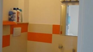 Kylpyhuoneessa on wc, bidee ja pesuallas. Hyllyllä on hygieniatuotteita.
