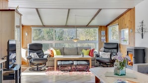 A cozy living room with a sofa, two chairs, a coffee table, and a fireplace. - "Ingebritt" - 1.5km from the sea by Interhome (Blokhus)