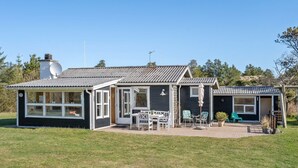 A two-story house with a patio area, a small garden, and a satellite dish. - "Ingebritt" - 1.5km from the sea by Interhome (Blokhus)