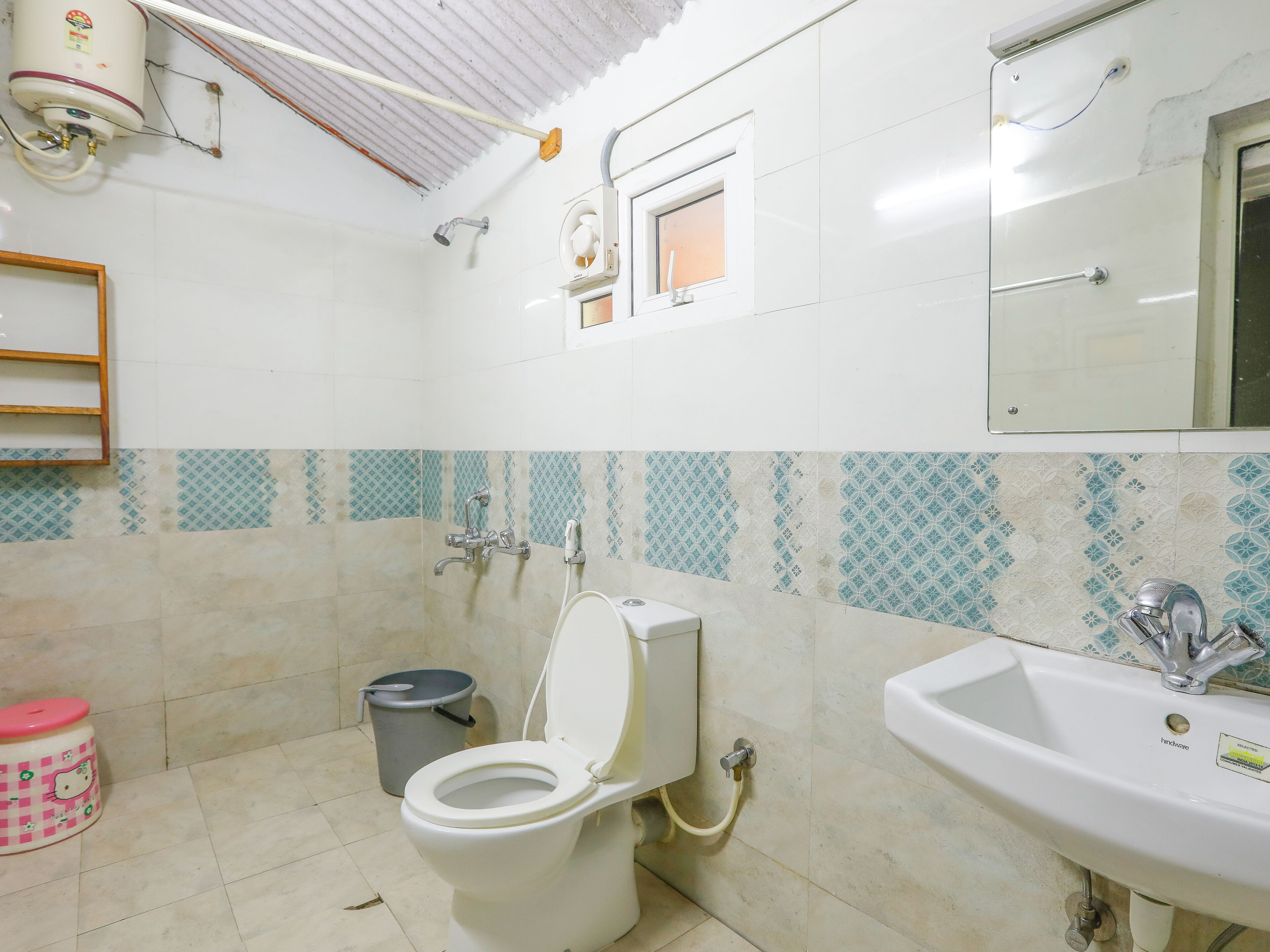 A bathroom with a toilet, sink, and shower.