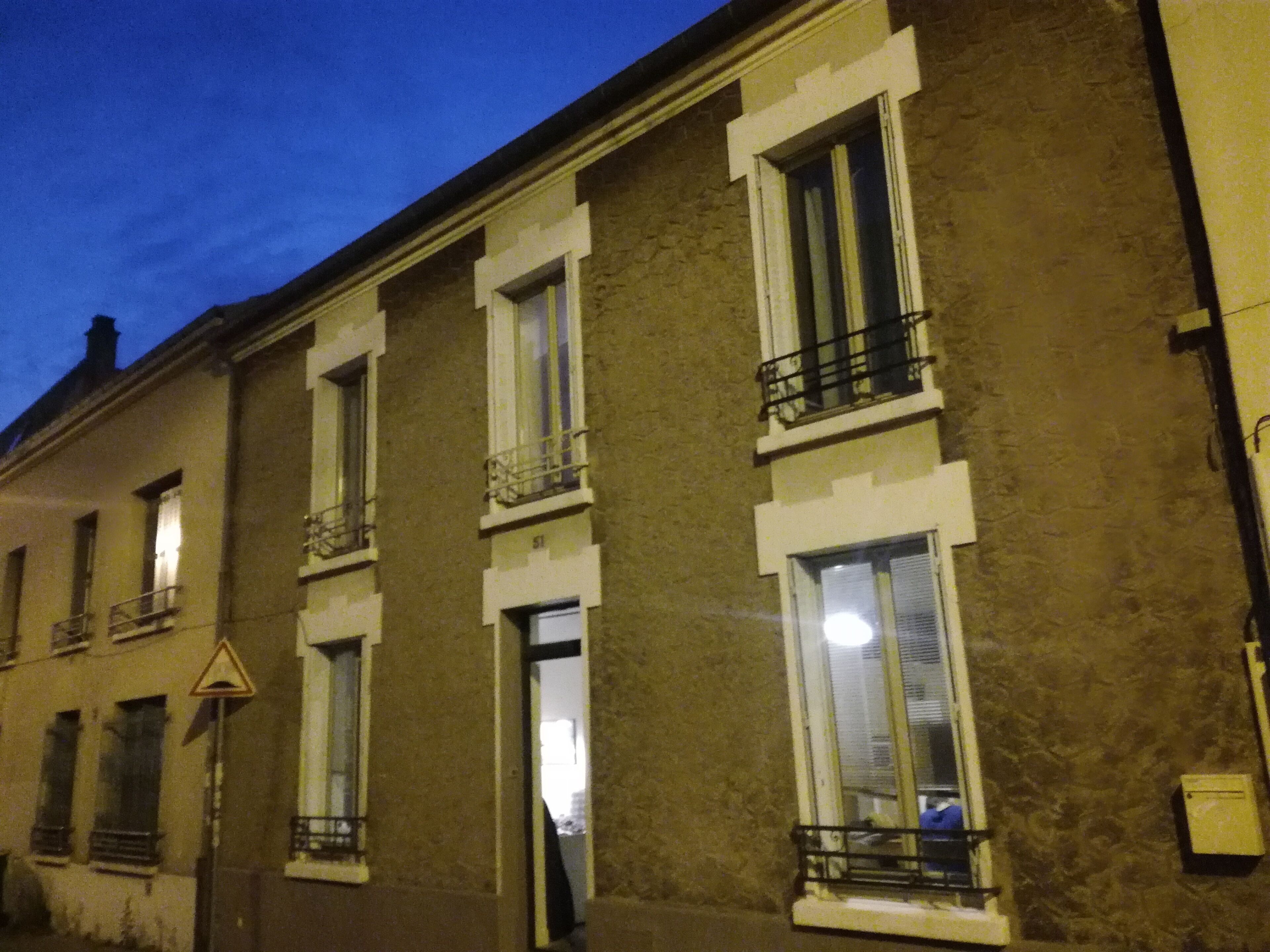A multi-story building with a consistent architectural style, featuring evenly spaced windows and balconies.