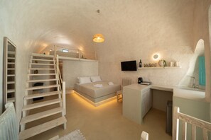 A compact bedroom with a bunk bed, a small desk, and a TV. - Marla Luxury Residences (Santorini)