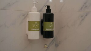 Two bottles of shampoo and shower gel on a marble surface. - Akshay valley Hotel & Restro (Udaipur)