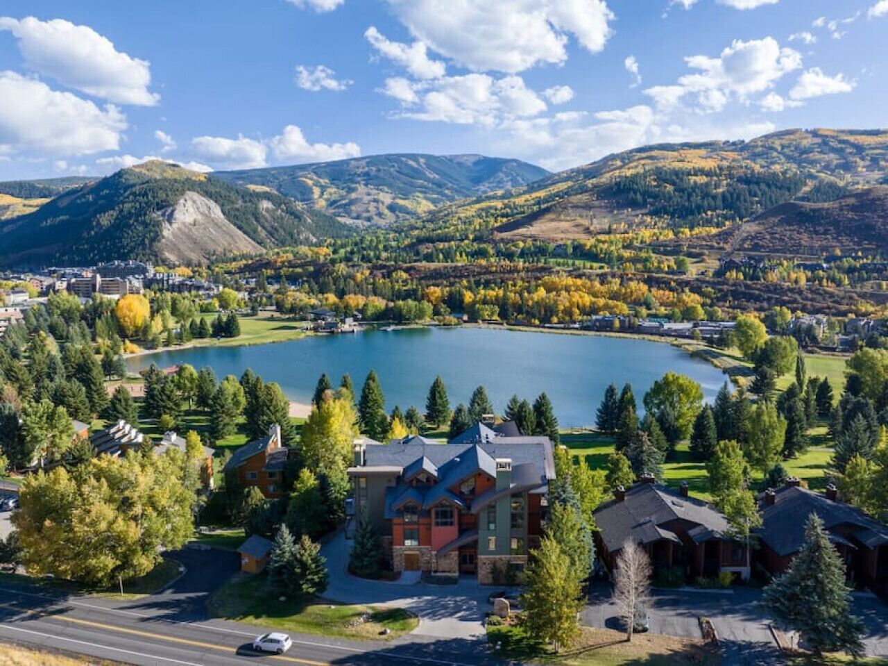 A large lake surrounded by residential buildings and trees.