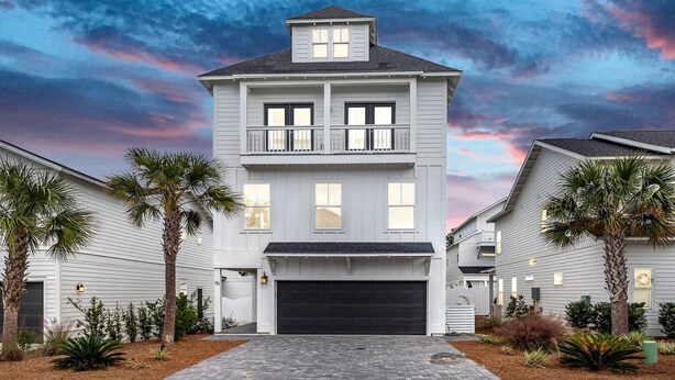 A two-story house with a garage, surrounded by palm trees and a well-maintained garden. - Inlet Beach! Sleeps 10, 4 BR/3.5 BA , Pool & just minutes to the beach, Rosemary area and 30Avenue! (Inlet Beach)