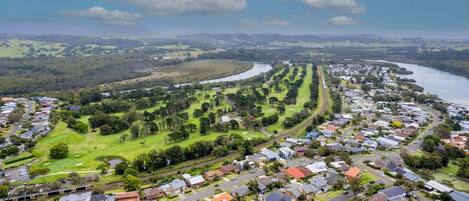 An aerial view of a residential area with houses, roads, and a river.