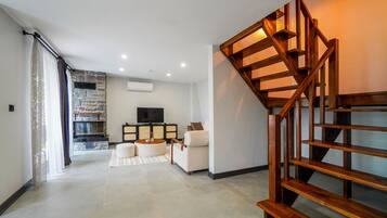 Deluxe Heated Pool Villa | Living area | 105-cm LCD TV with cable channels, fireplace, Netflix