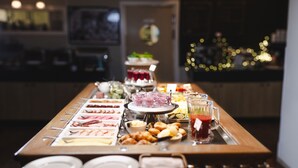 A buffet table with various food items and beverages.