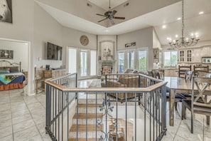A spacious living area with a high ceiling, a fireplace, a dining area with a chandelier, and a staircase leading to an upper level. - Summer Hikes! Mtn-view Gem w/ Hot Tub in Ruidoso (Ruidoso)