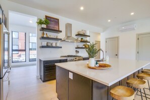 A modern kitchen with a large island, built-in appliances, and decorative shelves. - 10 Mi to Ski: Mtn-view Gem in Silverthorne (Silverthorne)