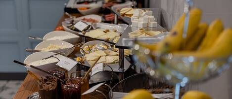 A buffet table with various food items and drinks.