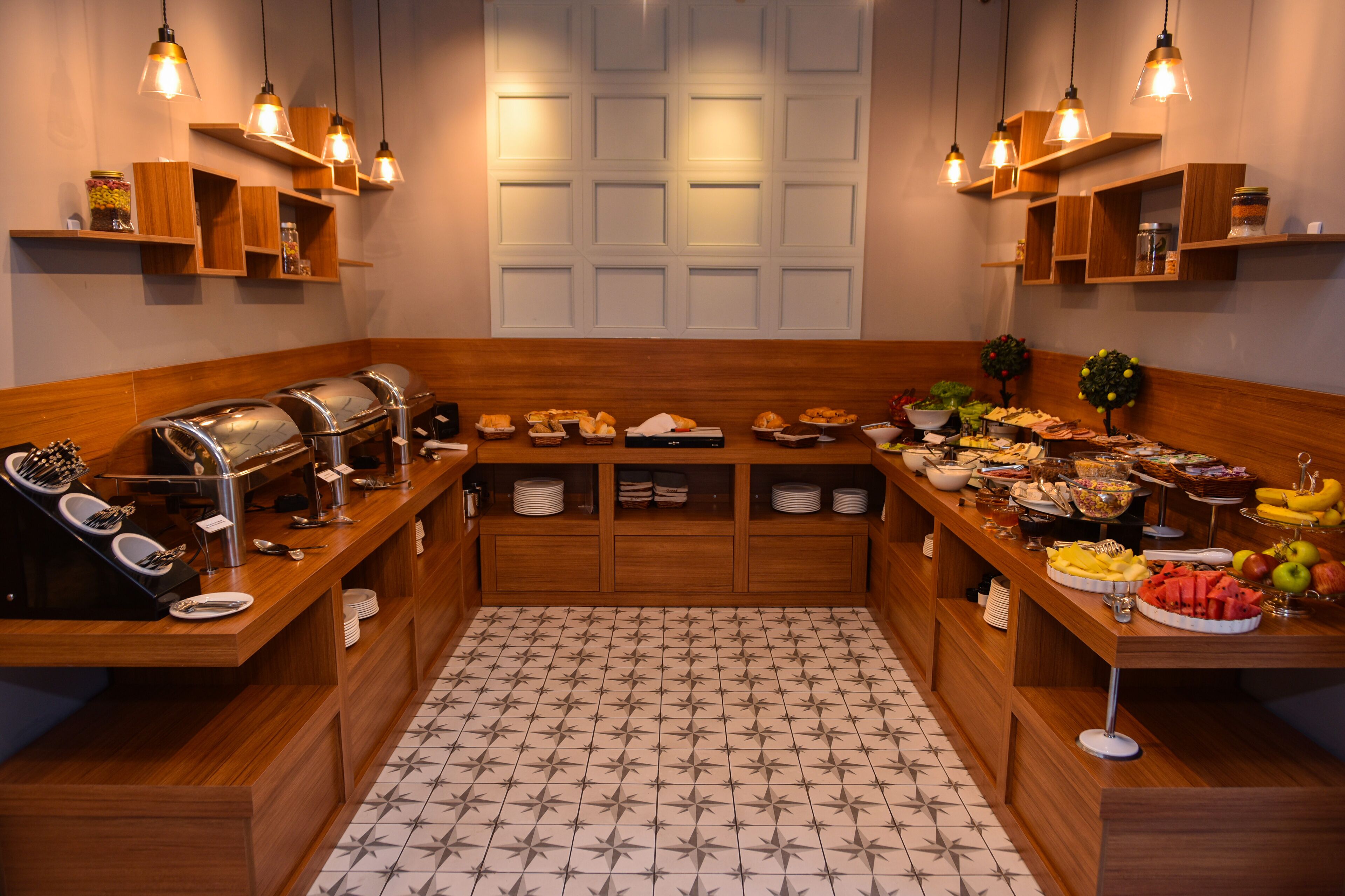 A buffet setup with various food items and a coffee station.