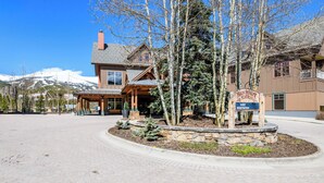 A lodge with a stone entrance, a sign for Main Station, and a mountain backdrop. - Luxury Resort Penthouse at Peak 9 Base/on Main St. (Breckenridge)