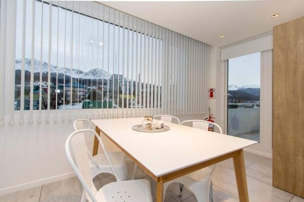 Enjoy a meal with a mountain view from the dining area, featuring a table and chairs.