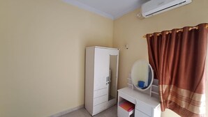 A room with a white wardrobe, a vanity with a mirror, and a brown curtain. - Hotel O Venus Homestay Syariah Near Universitas Megou Pak Tulang Bawang (Menggala)