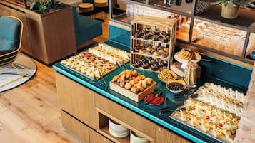 A buffet with various food items and a seating area with chairs and tables.